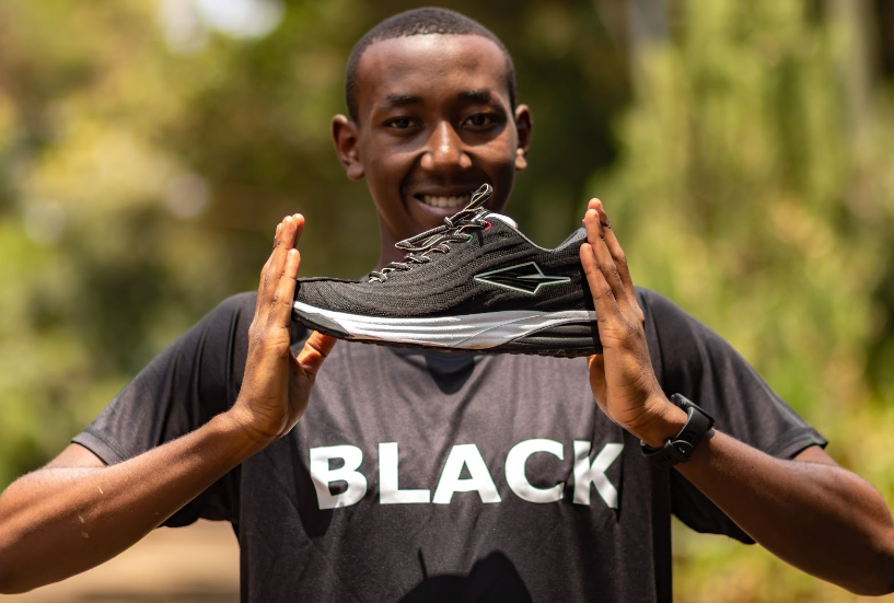 Model holding Black Lapatet shoes